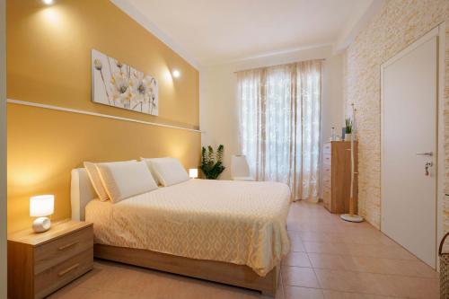 a bedroom with a large bed and a bathroom at Montellino's Suite Oro in SantʼAntìoco