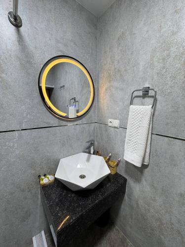 a bathroom with a sink and a mirror at Hotel Anor in Samarkand