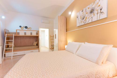 a bedroom with a bed and a bunk bed at Montellino's Suite Oro in SantʼAntìoco
