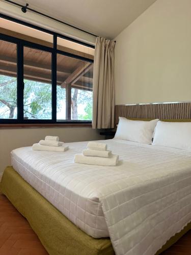 a bedroom with a large bed with towels on it at Podere Picarelly in Colonnella
