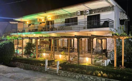 a lit up building with a balcony at night at My Afytos Garden in Afitos
