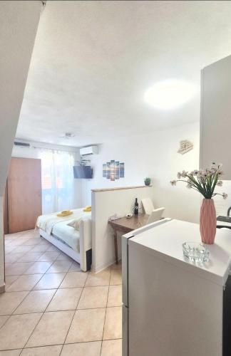 a bedroom with a bed and a table in a room at Apartments Mate in Komiža