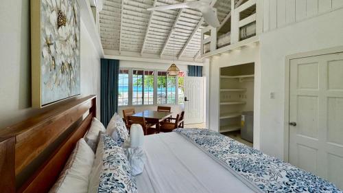 a bedroom with a bed and a table in it at Yellow Bird Sea in Negril