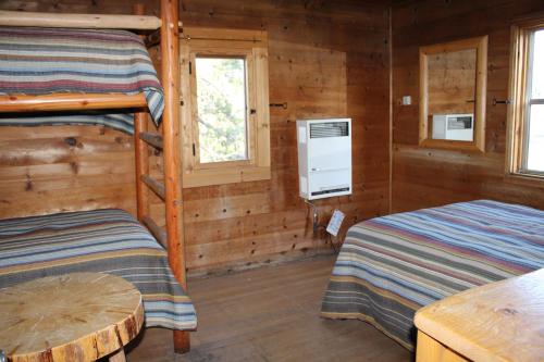 a bedroom with two bunk beds and a table at Drakesbad Guest Ranch in Chester