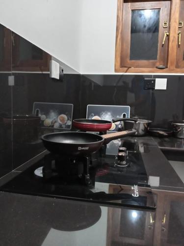 a pan on top of a stove in a kitchen at Ruwan's HomeStay in Matale