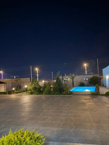 a parking lot at night with a swimming pool at Novxanı Villa in Baku