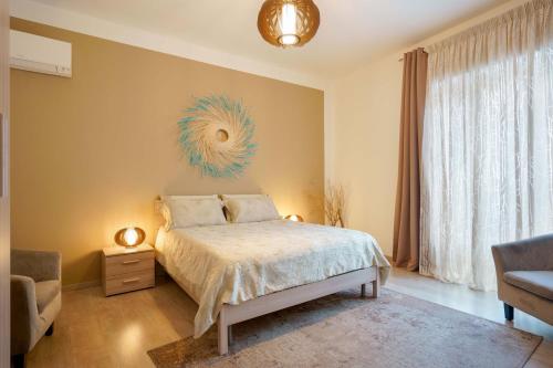 a bedroom with a bed and a large window at Montellinos Suite Tortora in SantʼAntìoco