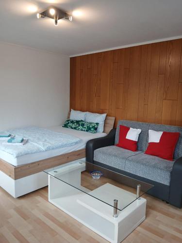 a living room with a couch and a coffee table at Zimmer mit Bad in Bühler