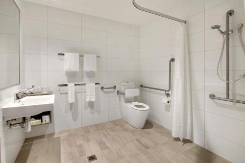 a bathroom with a toilet and a sink and a shower at Quest Macquarie Park in Sydney