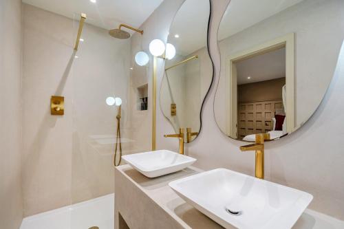 a bathroom with a sink and a mirror at Bell House in Amlwch