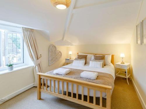 a bedroom with a large bed with two pillows at 3 Bed in Cullompton oc-85389 in Willand