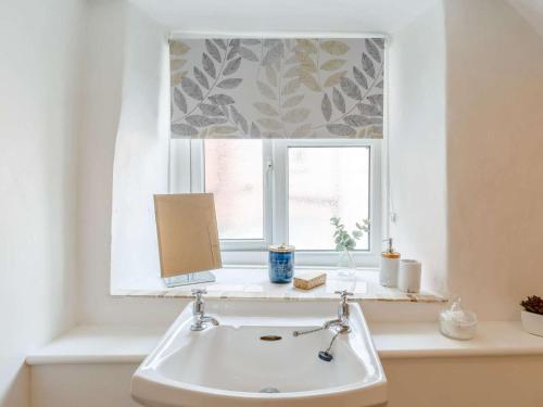 a bathroom with a sink and a window at 3 Bed in Cullompton oc-85389 in Willand