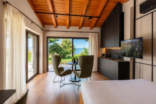 a bedroom with a bed and a table and chairs at Quercia Belvedere Relais in Bardolino