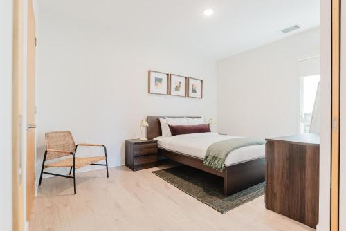 a bedroom with a bed and a chair at Joinery North in Charlotte