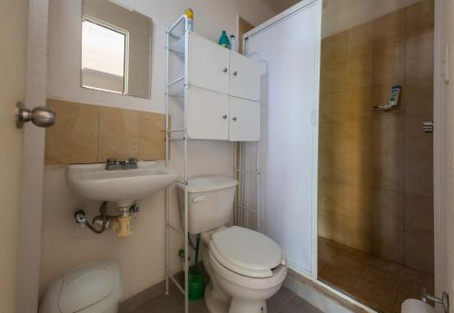 a bathroom with a toilet and a sink and a shower at Escape Turquesa in Los Algodones