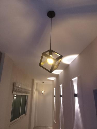 a light hanging from a ceiling in a room at Karak Castle House in Kerak