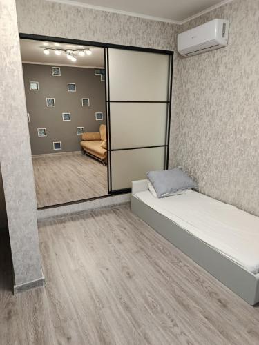 a room with two beds and a mirror at Fontanka Apartment in Fontanka