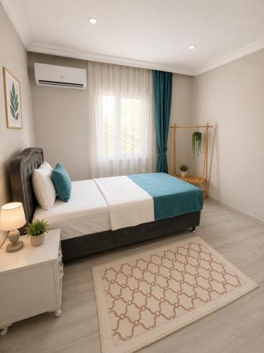 a bedroom with a large bed and a window at Apart Portakal Çiçeği in Kaş