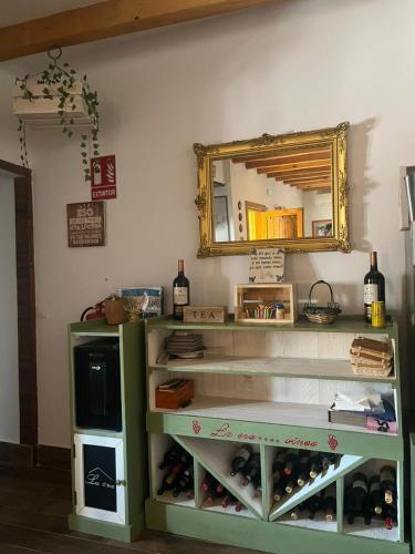 a room with a shelf with bottles of wine at La Era de Sandra in Sonseca