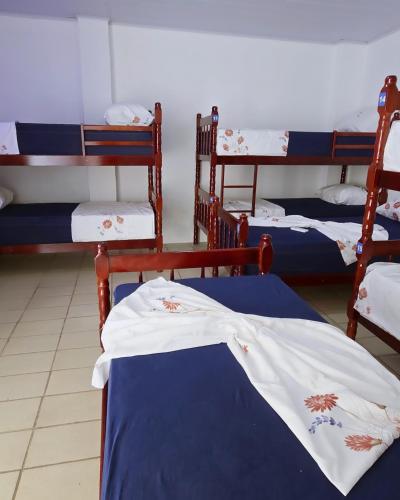 a group of bunk beds in a room at Home Hostel Maceió in Maceió