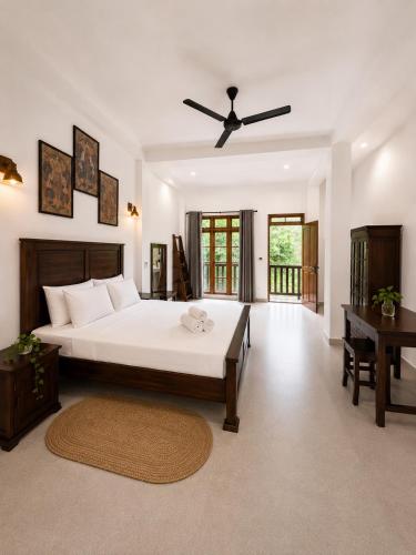 a bedroom with a bed and a ceiling fan at AZORA Boutique Studios in Ahangama