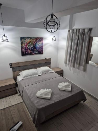 a bedroom with a bed with two towels on it at Flaburiotis House in Dhriopís