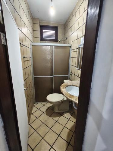 a bathroom with a toilet and a sink at durmaaquislz2 in São Luís