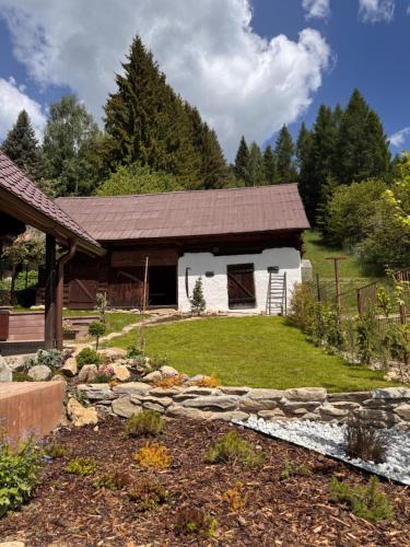 a house with a stone path in front of it at Drevenica Kráľova in Šumiac