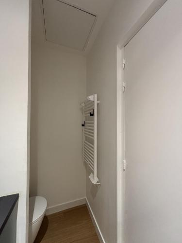 a bathroom with a toilet and a window at Appartement neuf & élégant- Centre Lorient in Lorient
