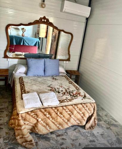a bedroom with a bed with a large mirror at Cabaña rural con piscina privada in Orihuela