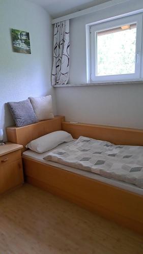 a small bedroom with a bed and a window at Apartment MASCH in Arriach