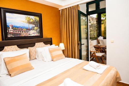 a bedroom with a large bed with a large window at Luxury Sea Residence by Kristina in Tivat