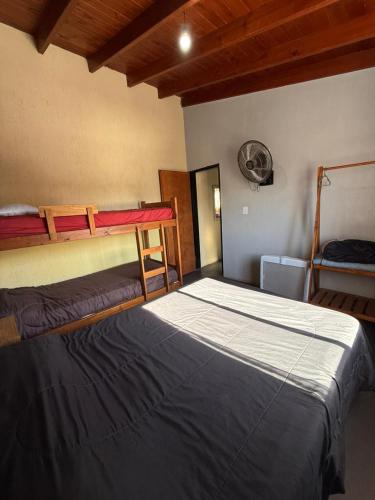 a bedroom with two bunk beds and a fan at Romedeptos II in Merlo