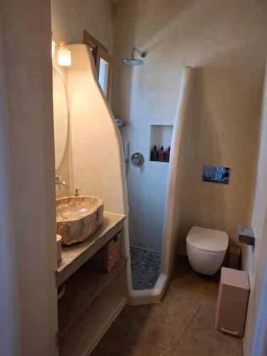 a bathroom with a sink and a toilet at ACHERONAS Residences in Serifos Chora