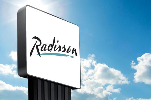a sign for a restaurant on a cloudy sky at Park Inn by Radisson, Fort Dodge Downtown in Fort Dodge