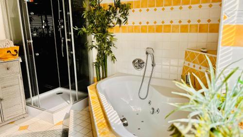 a bathroom with a bath tub with plants in it at CK Apartment in Oberhofen am Irrsee