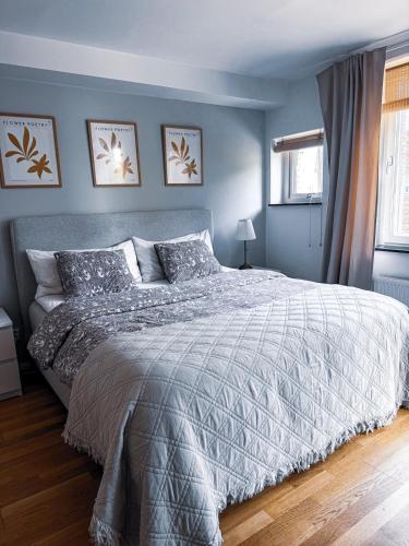a bedroom with a bed with a gray comforter at Apartment in Höganäs