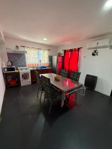 a kitchen with a table and chairs in a room at Romedeptos I in Merlo