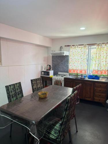 a kitchen with a table and chairs and a kitchen with a stove at Romedeptos I in Merlo