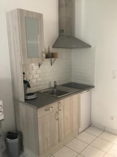 a small kitchen with a sink and a mirror at Chez titi et carole in Dissay-sous-Courcillon