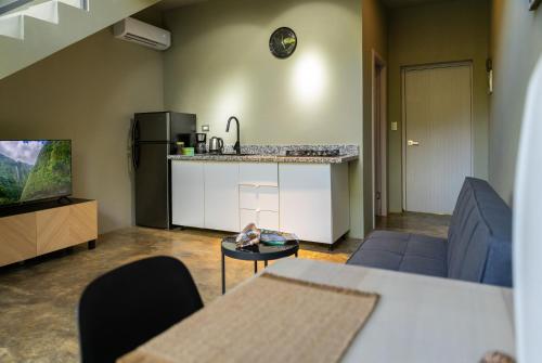 a living room with a couch and a kitchen at Elegant and Stylish - Riverside Tiny House Apartment in El Valle