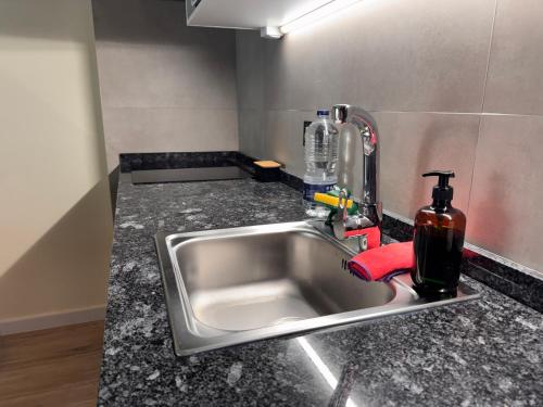 a kitchen sink with a soap dispenser next to it at Apartamento a 3 min de la playa, 10 min PortAventura World - Casa Márquez TAC - Costa Dorada in Salou