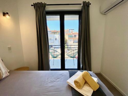 a bedroom with a bed with two towels on it at Spacious, Newly Renovated, Pula Rooftop Apartment with Marina Views in Pula