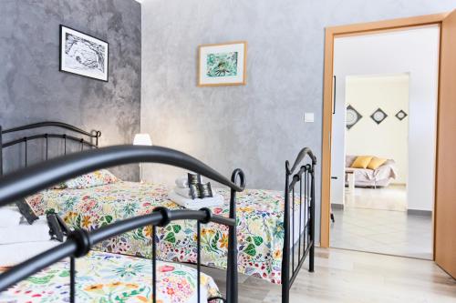 a bedroom with a bed with a floral bedspread at House Mellifera in Razvođe