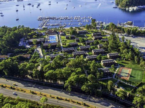 an aerial view of a park next to the water at Rixos Premium Göcek - Adult Only in Göcek