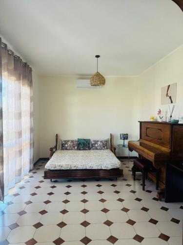 a bedroom with a bed and a piano at Villa Domini in Soverato Marina