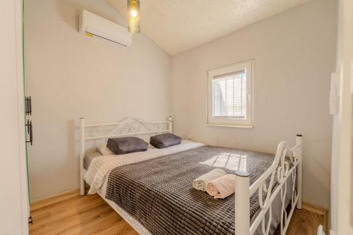 a bedroom with a white bed and a window at Nar Suites Alacati in Çeşme