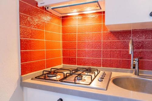 a kitchen with a stove and a sink at Nar Suites Alacati in Çeşme