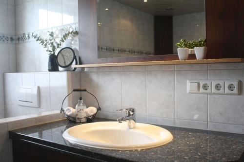 a bathroom with a sink and a mirror at Sonnseite in Punschern in Teisendorf