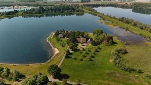 an aerial view of an island in a lake at Ferienwohnung Coproyshof - Direkt am See - 3 Schlafzimmer, privater Strand & Feuerstelle in Wesel